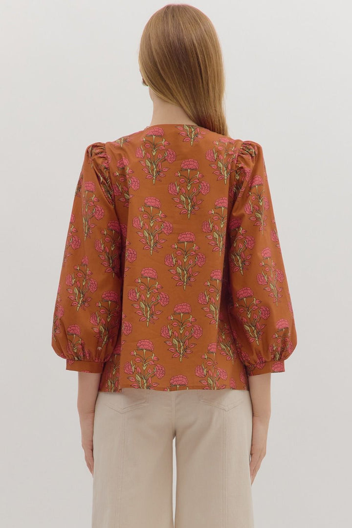 100% cotton Floral print long puff sleeve top featuring contrast embroidered knot trim V-neck