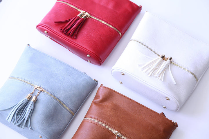 bright white, bright red, light blue, and light brown purses in Houston