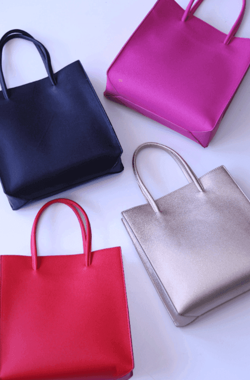 Bright red, hot pink, gold, and black rectangular bags at online women's boutique
