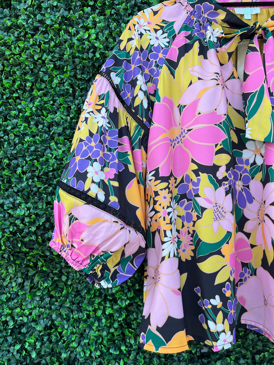 Bright floral blouse sleeve details from Tres Chic Women's Boutique in Houston