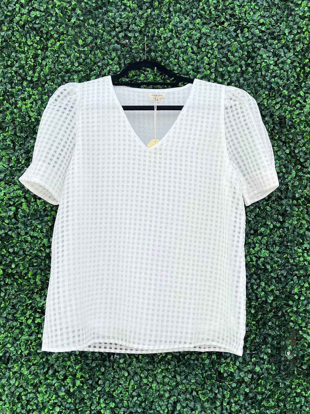 Bright white checker print top with sheer sleeve detail at Tres Chic