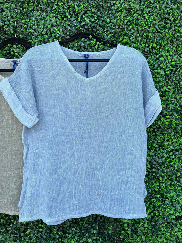 Dusty demin blue loose cuffed linen top from Tres Chic women's boutique on Eastside Street Houston Texas