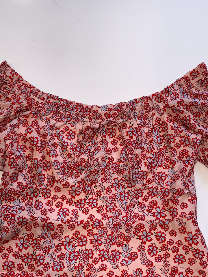 Bow detail on short floral dress in boutique